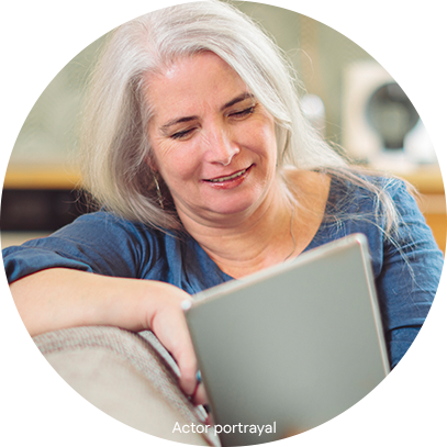 HCP_FinancialAssistance_Image_01 Patient portrayal of woman viewing a tablet computer